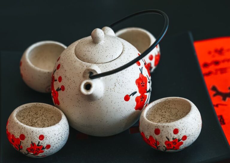 Close-up of a decorative tea set featuring a traditional floral design, ideal for cultural or culinary themes.