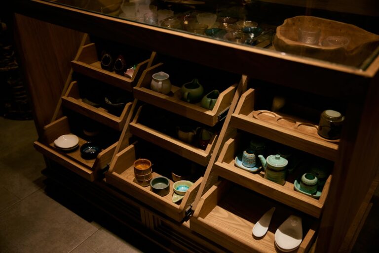 Wooden shelves display various ceramic and wooden items.