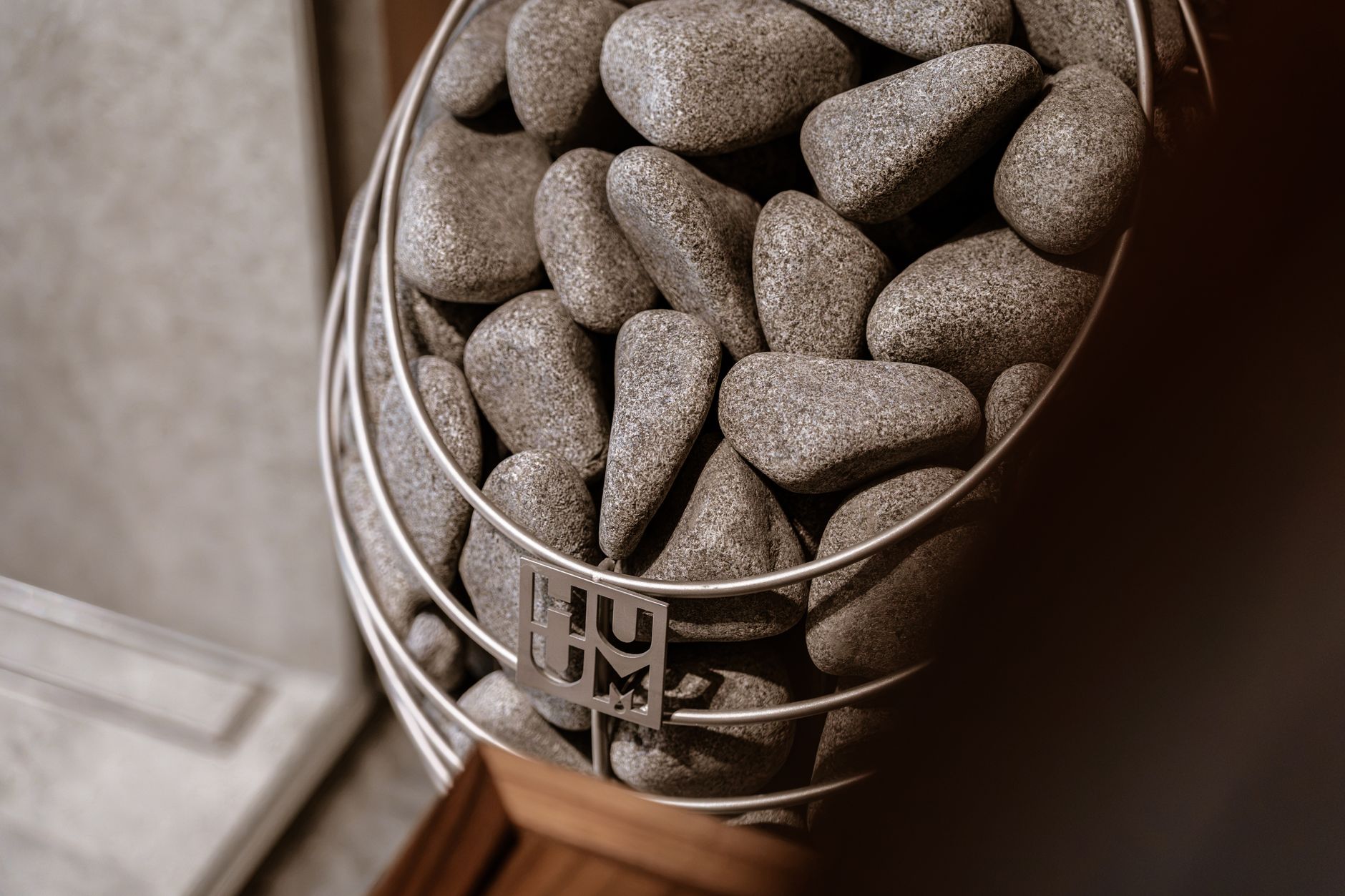 Contemporary sauna featuring a stylish Huum electric heater with stones, exuding Nordic design elegance.